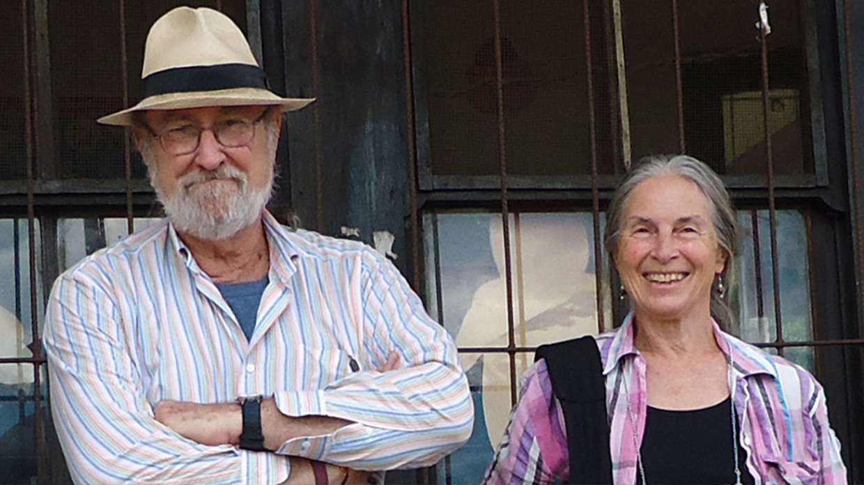 Earl and Suzanne posed for a photo in front of a building