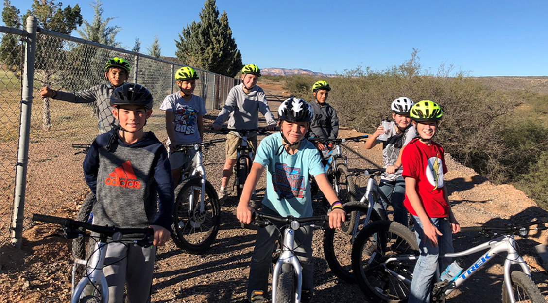 children on their bikes posed for a photo on a bike trail